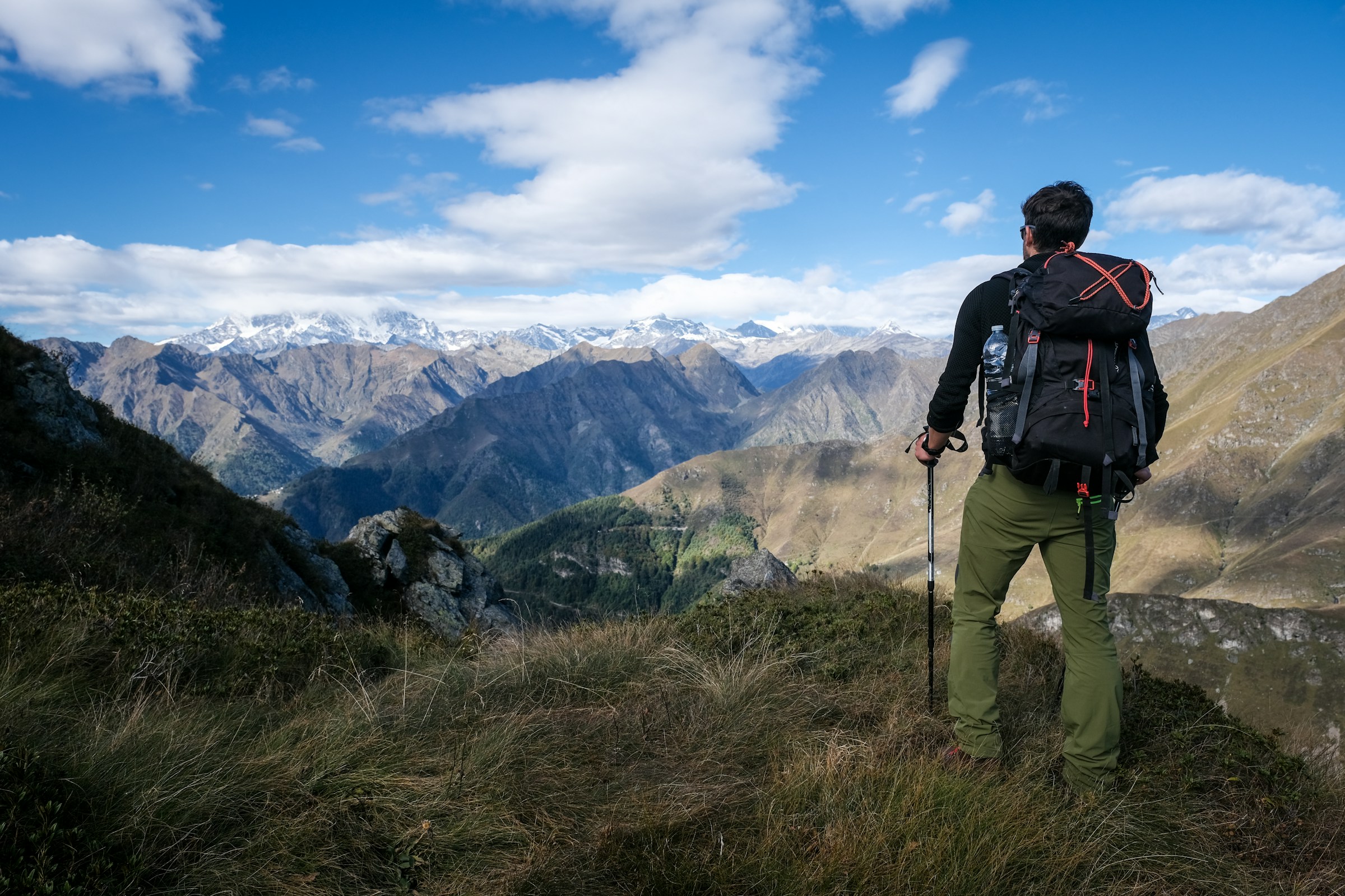 A hiker on a grass-covered hillside