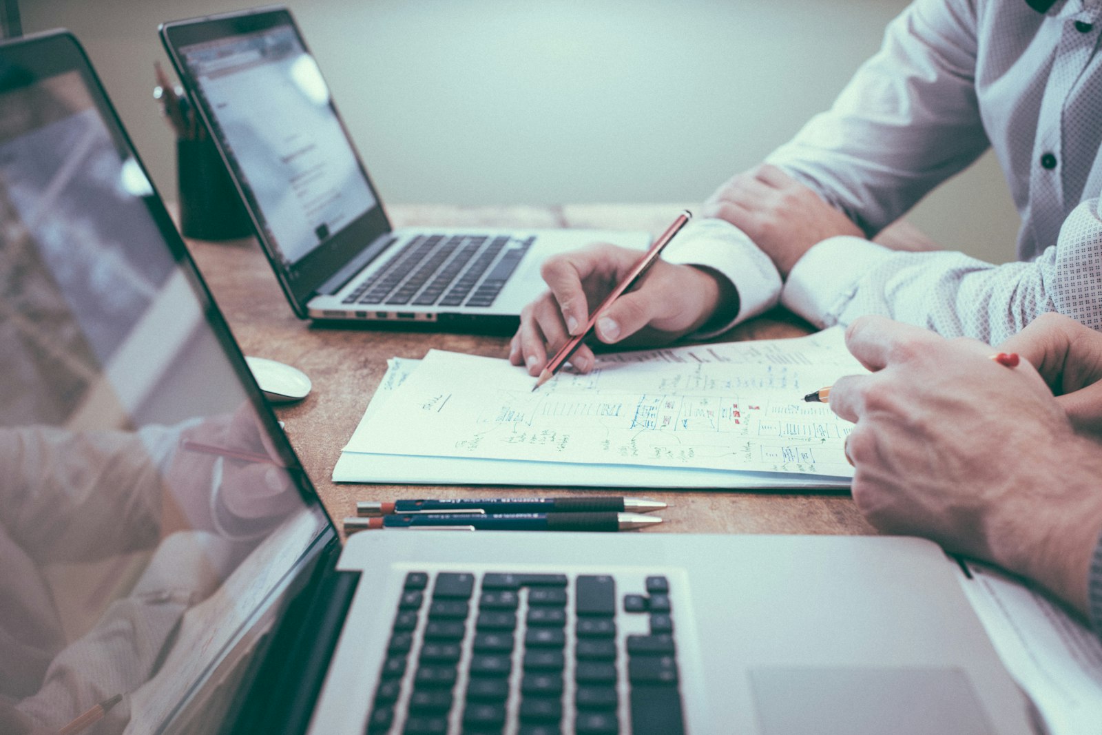 Legal compliance specialists reviewing corporate balance sheets and tax filings for EB-3 validity